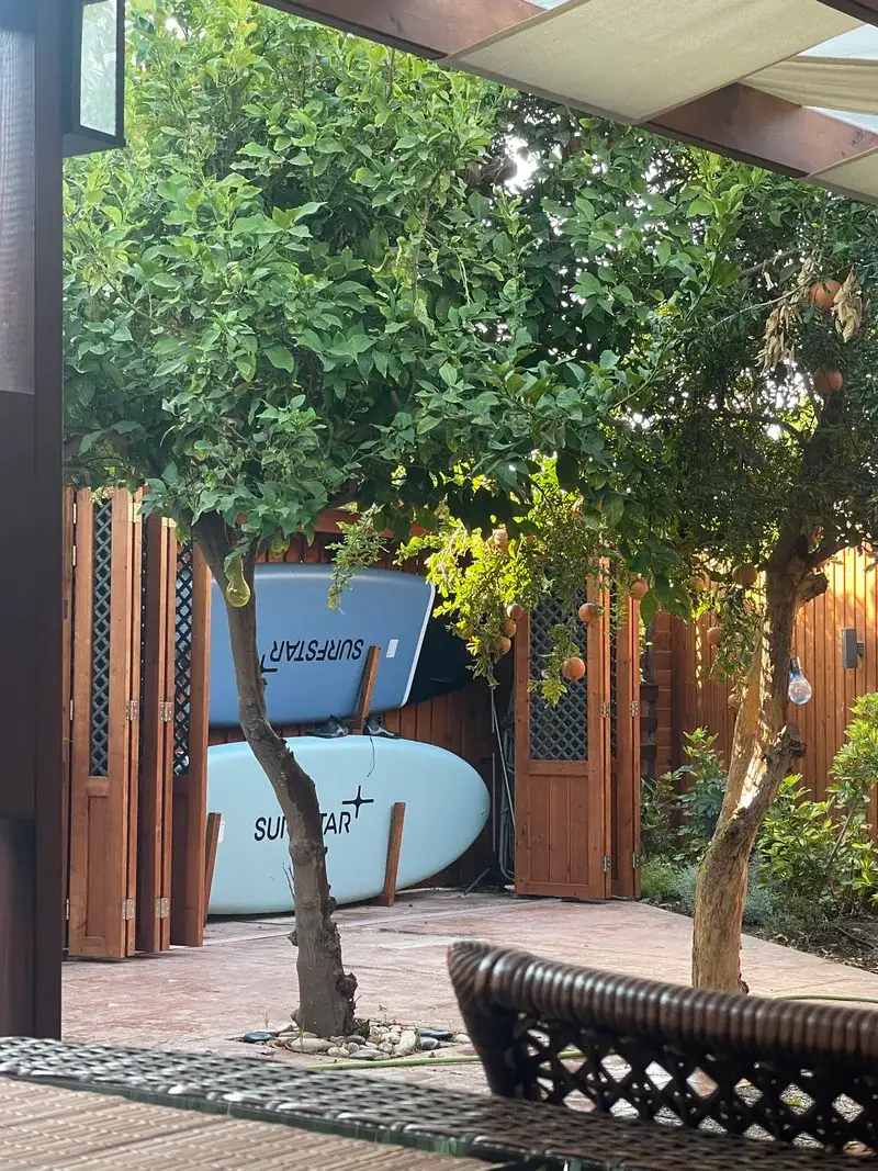 Private garden with surfboards and wooden decking