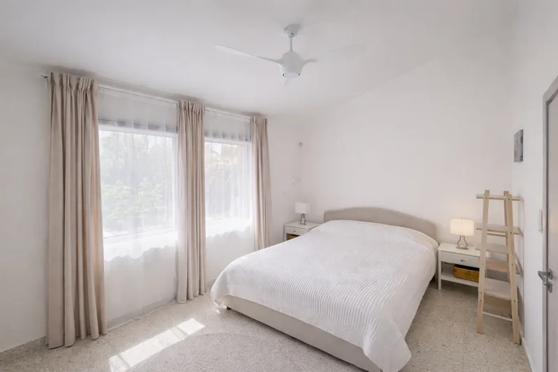 beachhouse cyprus bright minimal bedroom natural light garden view