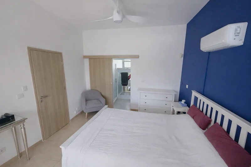 beachhouse cyprus modern bedroom blue accent wall bright clean interior